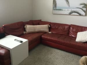 Red leather Natuzzi couch and ottoman