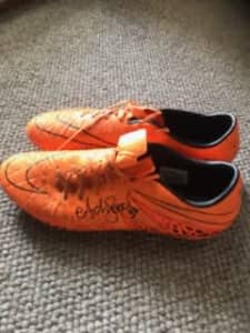 Adam goodes last game for swans boots with signature. 