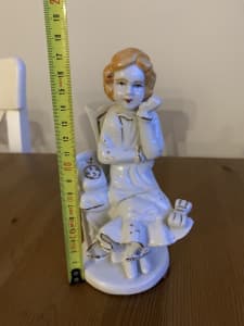 Figure of a woman beside the phone bargain $5