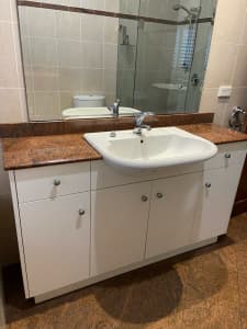 Granite top bathroom vanity and sink.