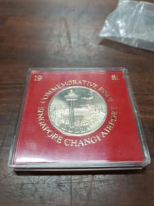 Singapore coin in red cover 