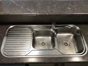 Stainless kitchen sink and mixer tap