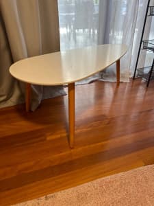 Surfboard-shaped, white, 3 legged coffee table