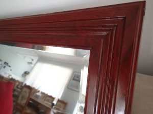 Bevelled edge mirror in a wooden frame