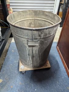 Old galvanised bin with handles glued on a dolly