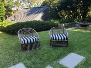 two vintage rattan chairs with stripey cushions
