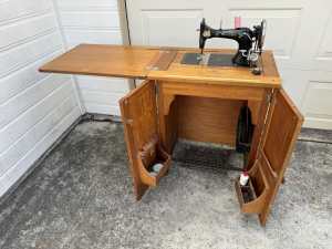 Antique sewing machine built in cabinet