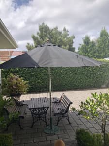 Outdoor table chairs and umbrella