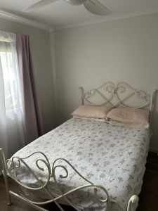 White metal double bed frame and mattress