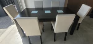 Solid timber dining table with leather chairs