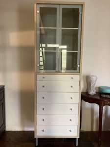 Tall cabinet with glass doors and drawers