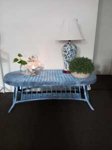 Cane table painted in blue with a splash of white and black