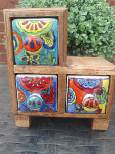 Wooden draws with ceramic hand painted pottery.