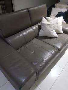 Leather grey lounge in good condition .