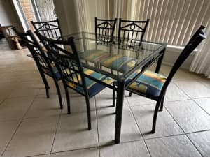 Glass top table on black metal frame & 6 chairs
