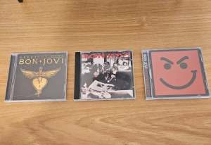 Three Bon Jovi cds, greatest hits, cross road & have a nice day