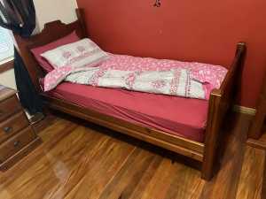 Single bed, mattress and side table.