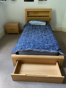 Single bed with mattress and bedside table