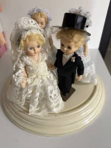 Bridal party dolls in glass dome casing