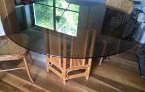 Dining table with rattan and bamboo base 135 cm tinted glass top