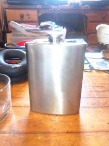 An as new 7 ounce stainless steel hip flask