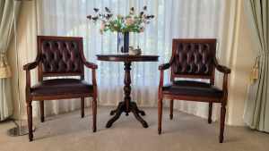 Round wooden table with 2 matching leather-classic Chesterfield chairs