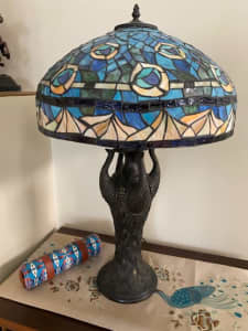 A pair of matching lead light lamps with colourful peacock motif.