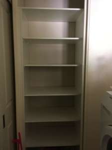 big laundry cupboard with two big sliding double doors