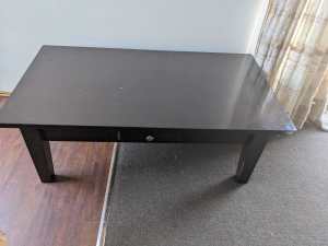 slightly dinged coffee table with drawer