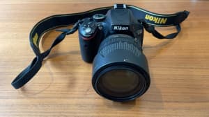 Nikon D5100 DSLR with 18-105mm lens, charger, bag and spare battery