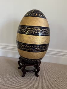 Large ceramic egg with black and gold design