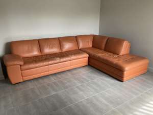 Corner leather lounge with ottoman