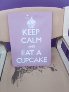 A keep calm and eat a cup cake sign