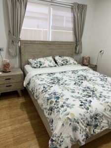 Queen bed with 2 bed side tables and a tallboy