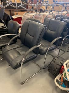 2x black leather office visitor chairs