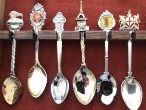 36 mostly international spoons in a wooden display case.