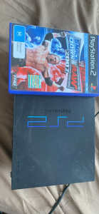 PS 2 console with Smackdown vs raw game