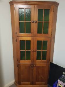 CORNER CUPBOARD WITH GLASS DOORS AND SHELVES.