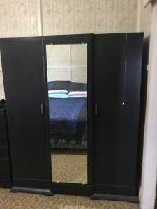 Lovely solid wooden wardrobe. Two door , centre mirror, hanging area,