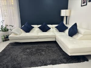 White L shape lounge AND Charcoal rug