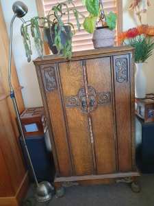 Antique carved oak radiogram cabinet.