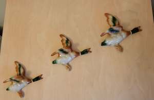 Ceramic wall hanging flying ducks.