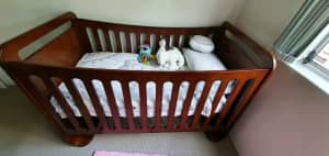 Baby cot convertible to a bed