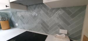 Subway tiles with varying color tones and irregular edge