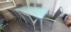 Outdoor Glass table 2100x1000x725, includes seven chairs.