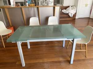 Extending glass dining table