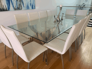 Large glass and stainless steel dining table and 12 chairs