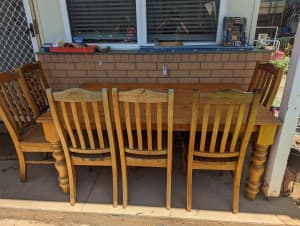 Large solid wooden table set with 6 matching wooden chairs