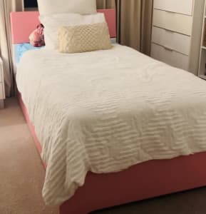 Pink king single bed frame and roll out trundle.