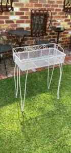 Old white metal plant stand
